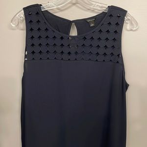 Black tank top with cutout yoke.
